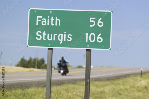 State Highway 34 with highway sign for Sturgis South Dakota and motorcycle driver heading for the 67th Annual Sturgis Motorcycle Rally, Sturgis, South Dakota, August 6-12, 2007