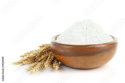 Wheat flour in wooden bowl isolated on white