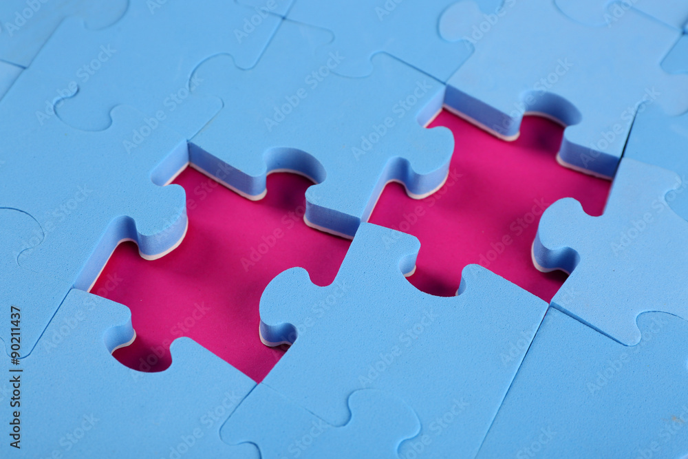 Fototapeta premium Missing puzzle pieces on pink surface, closeup