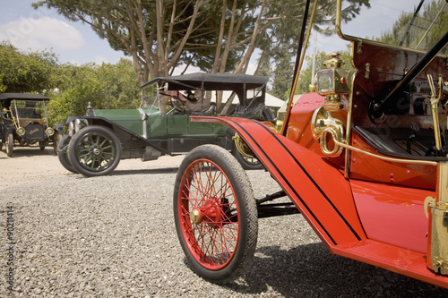 Antique cars parked in an orange grove at horseless carriage rally in Santa Paula, CA photo