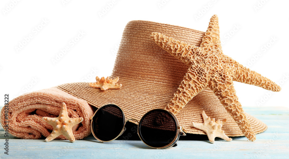 Naklejka premium Summer accessories on wooden table isolated on white