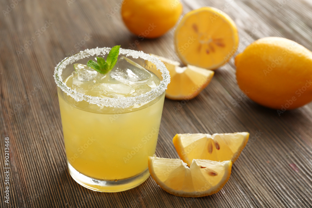 Glass of lemon juice on wooden table, closeup Glass of lemon juice on wooden table, closeup