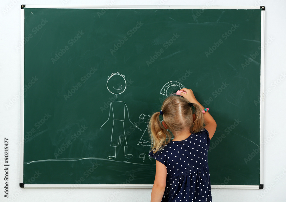 Girl drawing on blackboard, close-up Girl drawing on blackboard, close-up