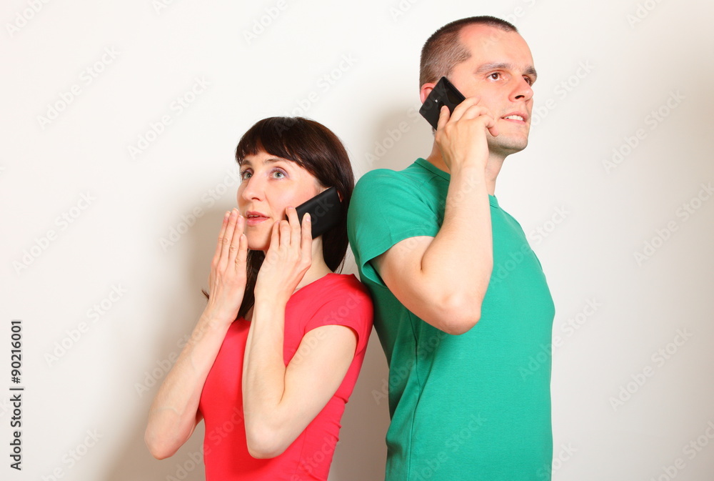 Shocked woman and man talking on mobile phone Shocked woman and man talking on mobile phone