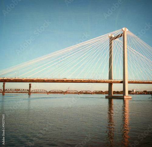 aged and worn vintage photo of suspension bridge
