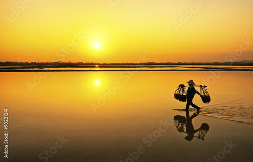 Farmer going home after a hard working day in Hon Khoi salt field, Nha Trang, Vietnam 