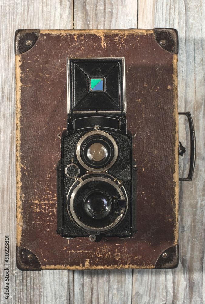 Vintage photo camera on wooden background