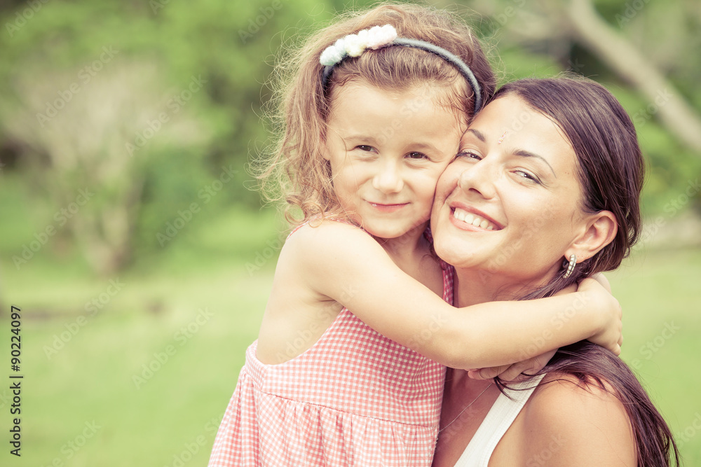 Happy mother and daughter playing in the park at the day time. Happy mother and daughter playing in the park at the day time.