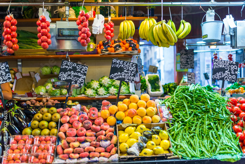 Price tags on market stall. Fruits and vegetables for sale at La Boqueria, a large public market in the Ciutat Vella district of Barcelona	 photo