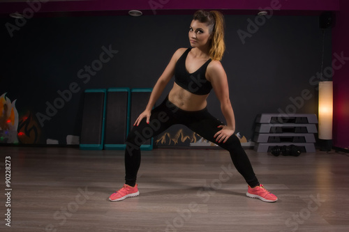 Fit women stretching the muscles of her legs