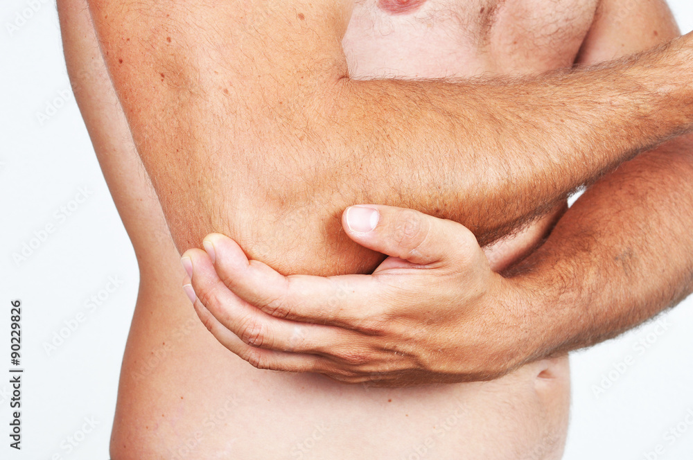 Man holding his elbow because of a pain. Man holding his elbow because of a pain.
