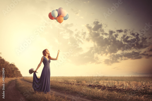 girl in blue dress with bouquet and balloons
