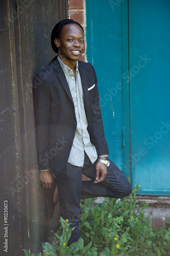 Happy Black man outdoors smiling in a suit coat