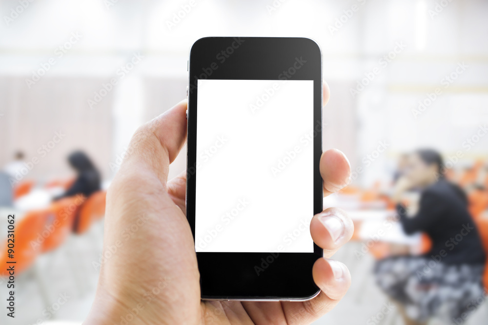 Close up of hands man holding smart phone with blank screen on blurred people background
