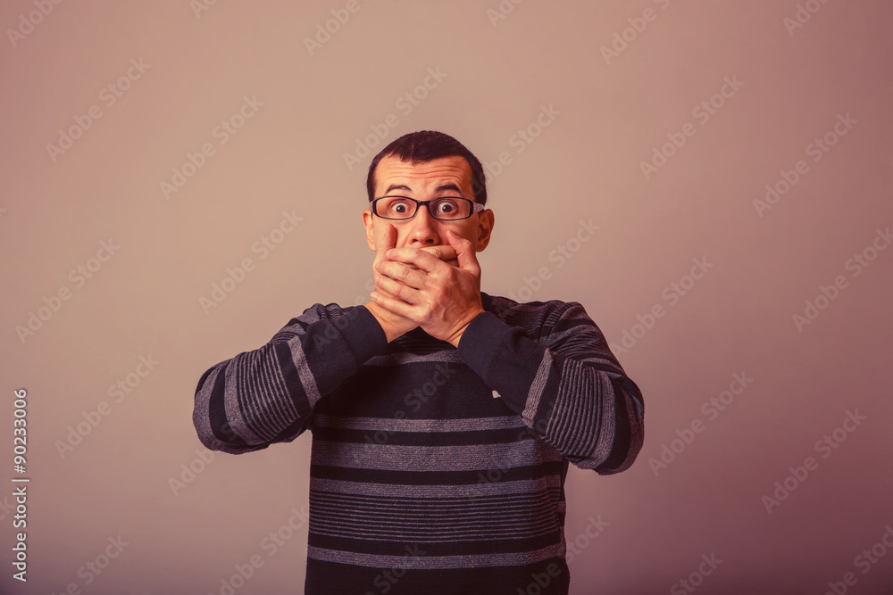 Fototapeta premium European-looking male of about thirty-closed mouth with her hand
