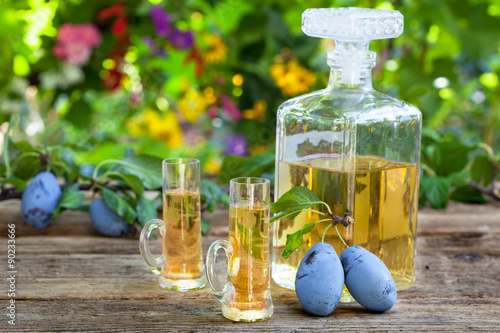 Fotografia, Obraz Bottle and two glasses with plum brandy