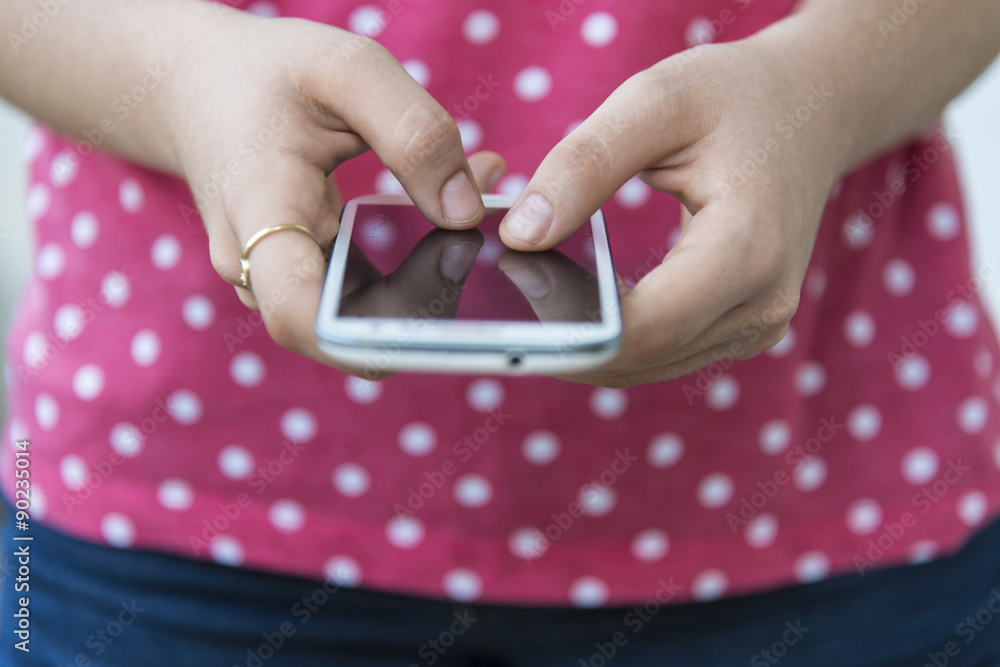 Fototapeta premium Teenage girl using mobile smart phone