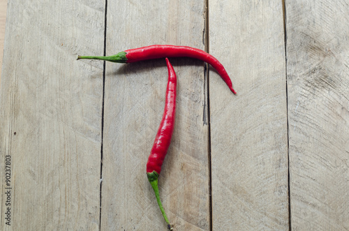 Red chili on an wooden background.