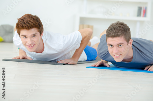 Teenage friends doing push ups
