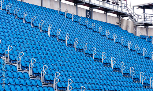 rows of blue seats in a stadium