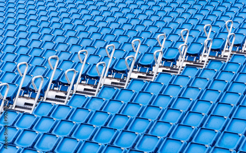 rows of blue seats in a stadium