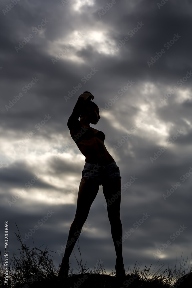 Female silhouette on sky backdrop