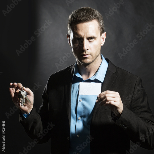 Man with card and keys bunch photo