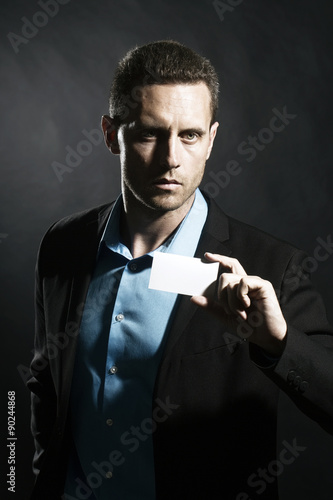 Serious man with card photo