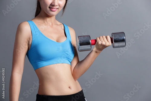 Sport woman is lifting weights