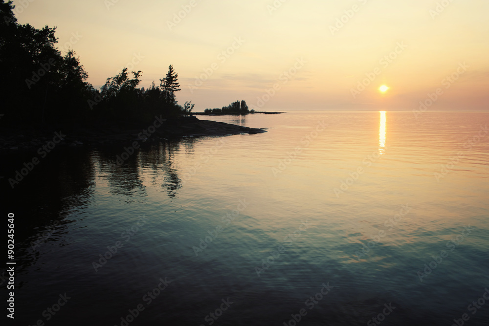 Ladoga lake at sunset. Aged photo in retro style.