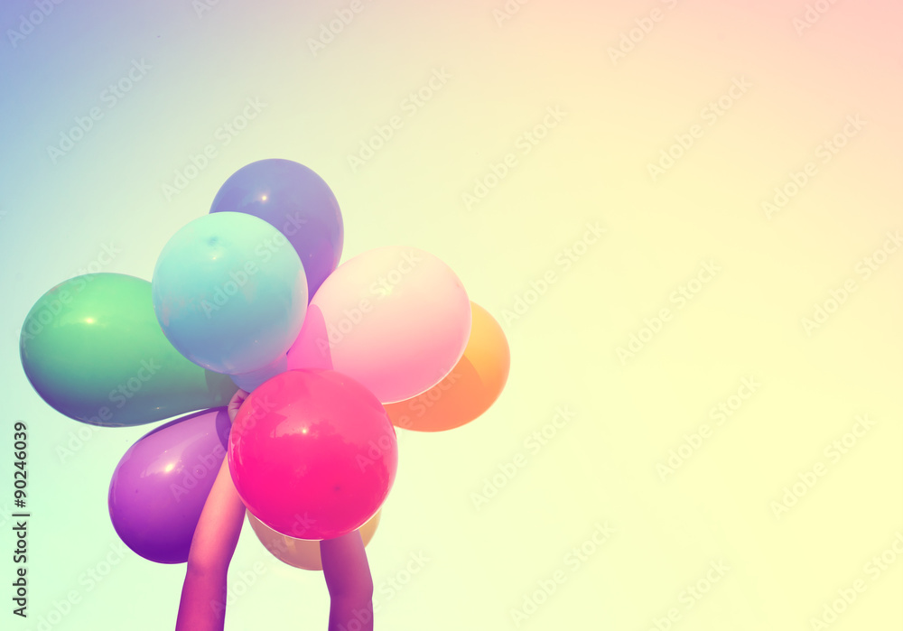 Girl hand holding multi colored balloons done with a retro vintage  instagram filter effect, concept of happy birth day in summer and wedding  honeymoon party (Vintage color tone) Stock Photo | Adobe