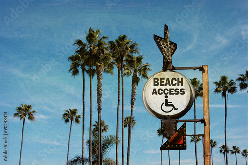 aged and worn vintage photo of beach access sign