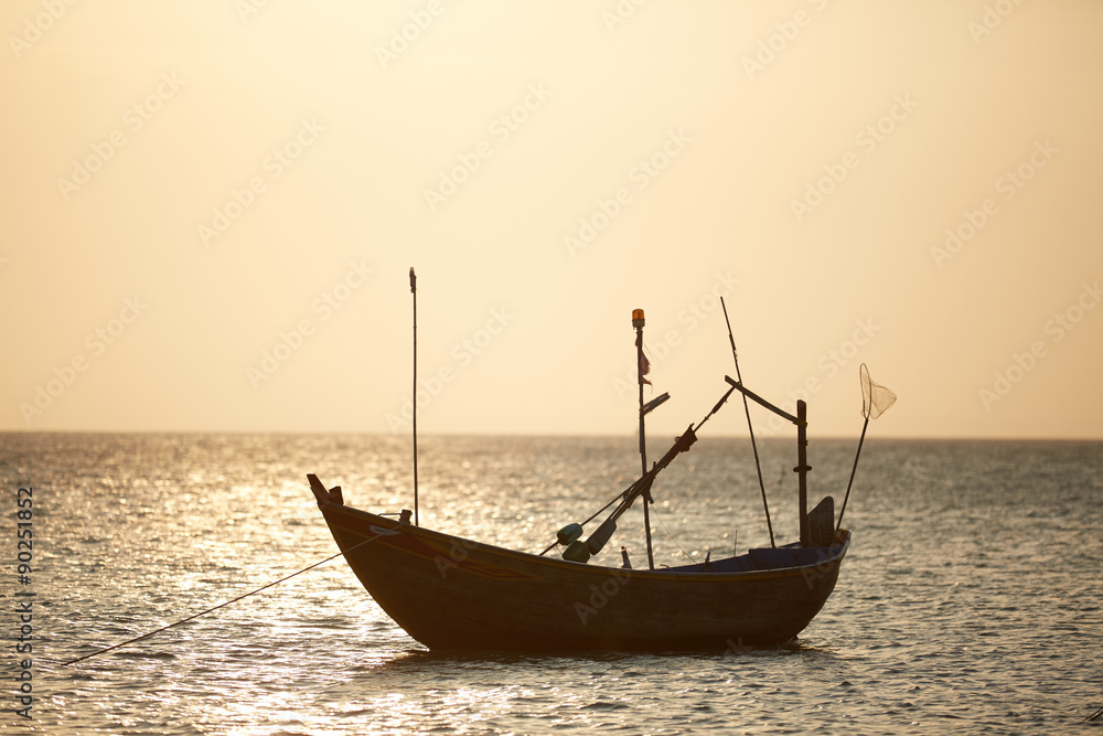 Fototapeta premium fishing boats in the sea at sunset