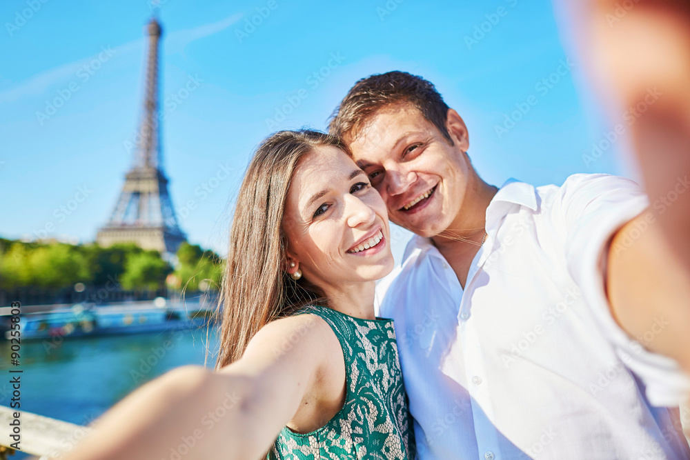 Young romantic couple making selfie near the Eiffel tower Young romantic couple making selfie near the Eiffel tower