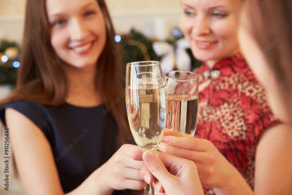 three beautiful girls on New Year's party with champagne three beautiful girls on New Year's party with champagne