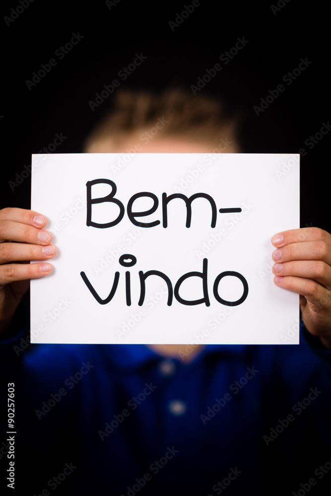 Child holding sign with Portuguese word Bem-vindo - Welcome Child holding sign with Portuguese word Bem-vindo - Welcome