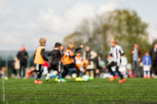Blurred young kids playing football