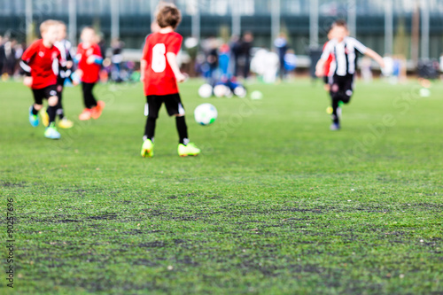 Blurred young kids playing soccer