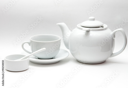 white tableware, large kettle, Cup, bowl, porcelain spoon on a