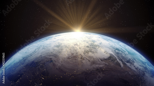 3 D render of Earth with Sun rising. photo