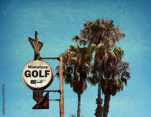 aged and worn vintage photo of miniature golf sign