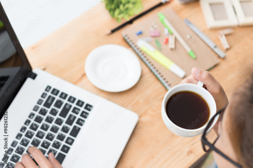 woman drink coffee and use laptop computer on desk woman drink coffee and use laptop computer on desk