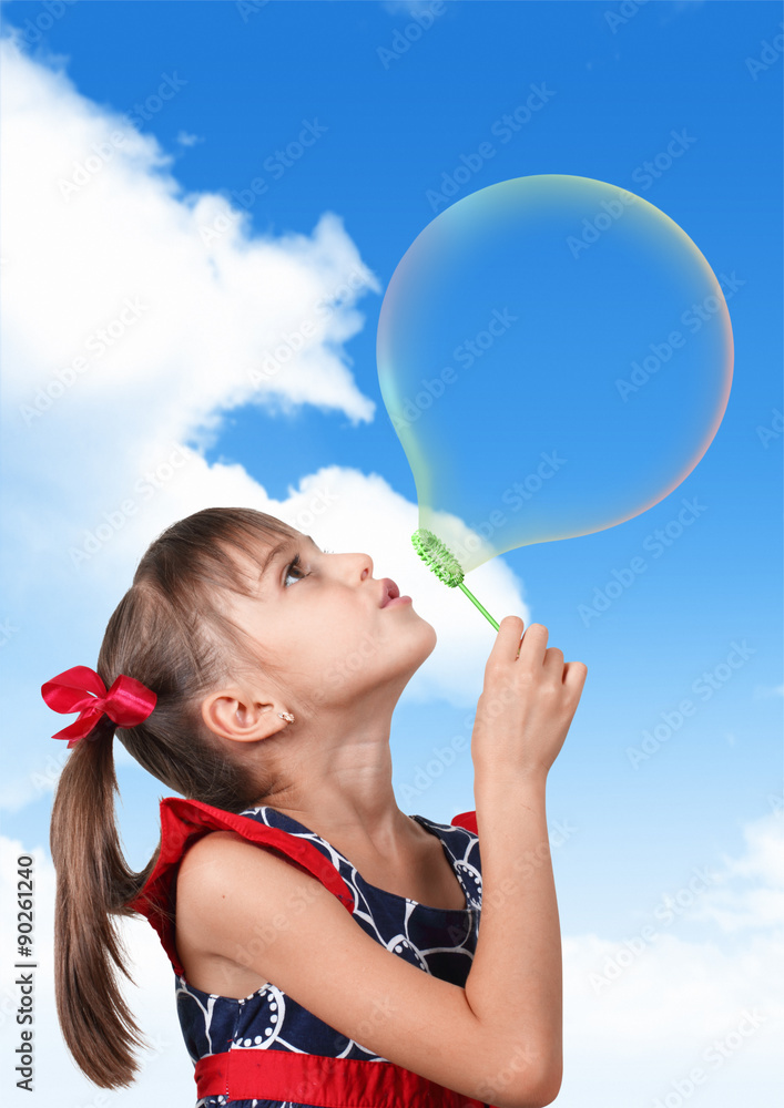 Portrait of funny child girl blowing big soap bubble on sky back Portrait of funny child girl blowing big soap bubble on sky back