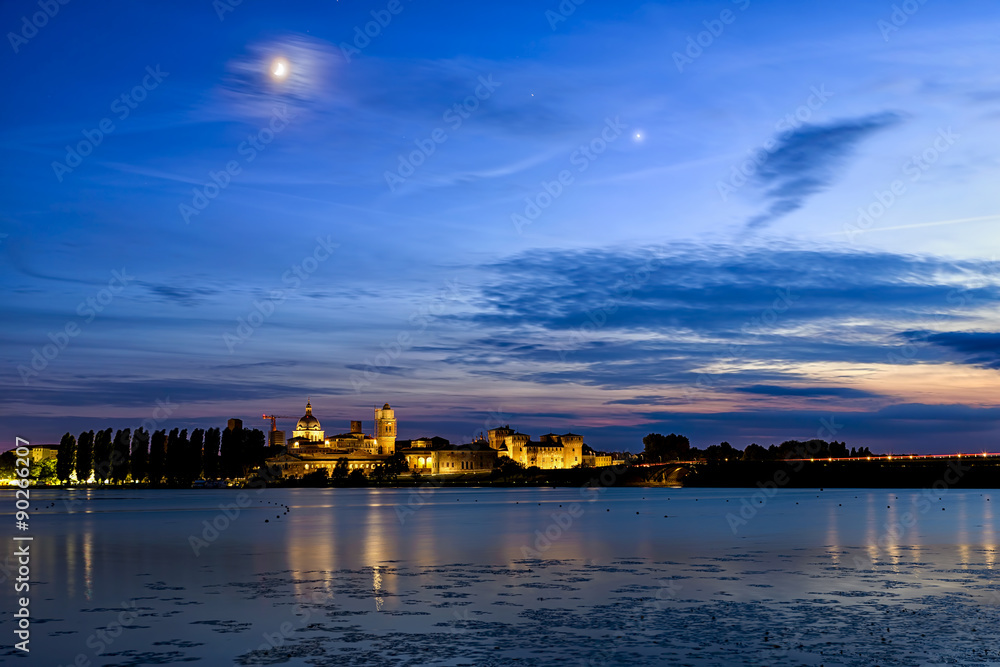 Mantua night skyline on river with moon