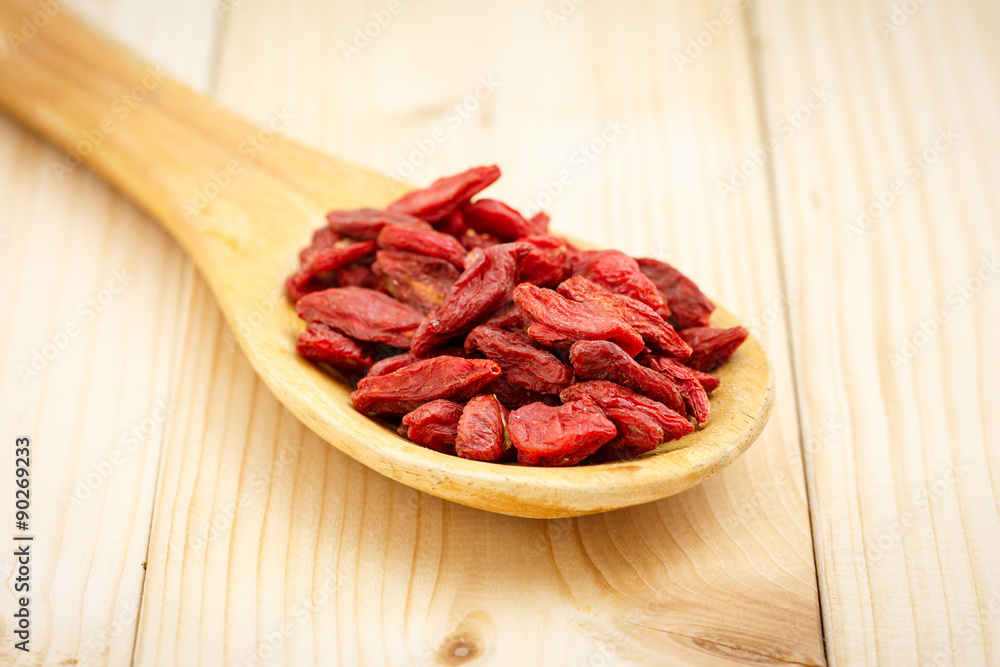 Dry red goji berries in wooden tablespoon