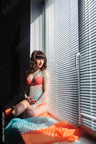 Young pregnant woman with bodyart on her belly studio shot © Iosif Yurlov