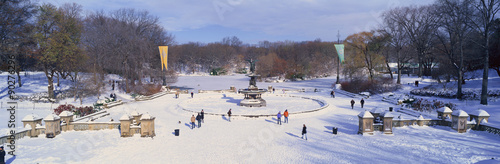 Panoramic view of water fountain covered with fresh winter snow in Central Park, Manhattan, New York City