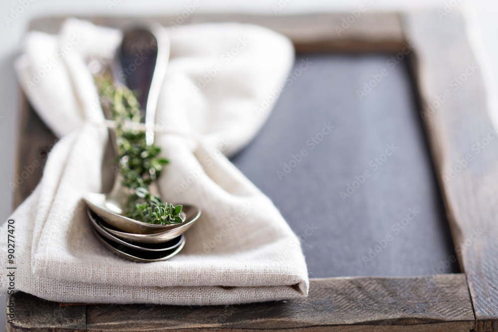 Tablespoons with a napkin and thyme
