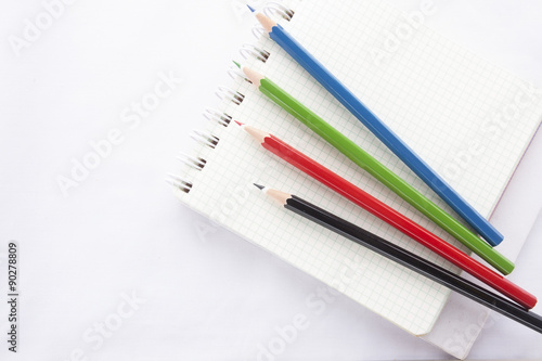 Color pencils and the ring binder book isolated on white background
