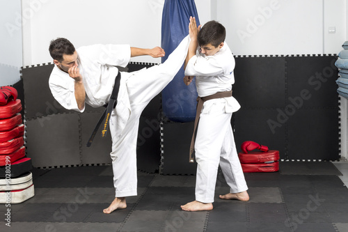 Two young men in kimono fighting- ashihara karate-during their t photo